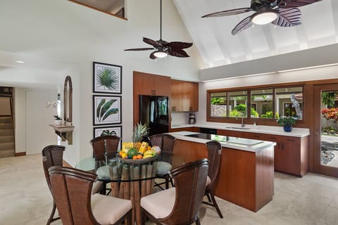 Kitchen and dining space featuring modern appliances and an island with seating for 6.