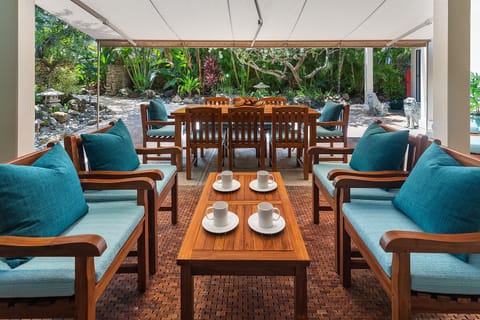 Main House outdoor Dining area with seating for six, offering a cozy setting for al fresco meals amidst tropical surroundings.