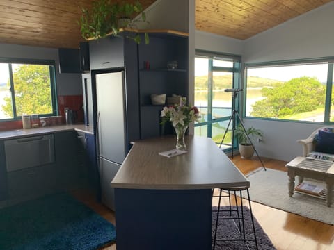 Kitchen flow into seating area with balcony