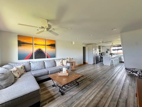 The living room provides a large, comfortable sofa for lounging.