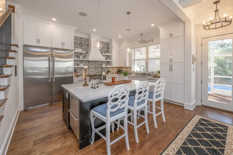 The gourmet chef's kitchen features a spacious layout with counter seating for four, perfect for casual dining or entertaining.