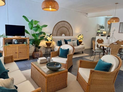 Air-conditioned, spacious living/dining room showing clic-clac sofabed