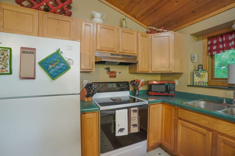 Stove, microwave, wooded view over kitchen sink... 