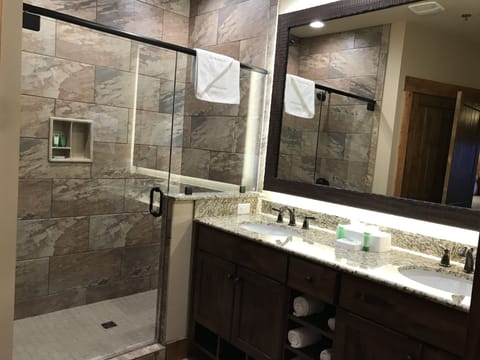 Large bathroom with double sink and shower.