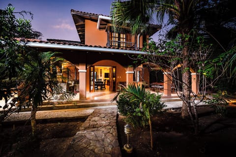 Front of villa from garden walkway at twilight