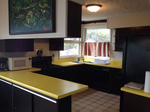 A fully equipped spacious kitchen with lots of bright yellow counter space.