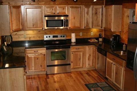 Stainless steal appliances, granite countertops and hickory wood floors