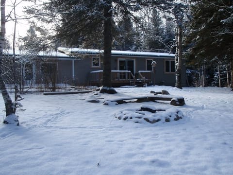 Cabin from the rivers edge in winter