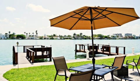 Back of property includes shaded seating and 3 boating docks.