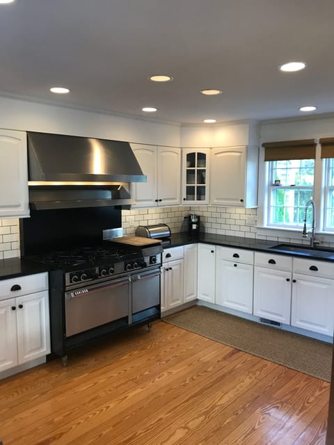 renovated kitchen with six burner stove, new refrigerator and dishwasher
