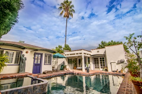 Black bottomed pool and hot tub with saline water next to the 
pool cabana.