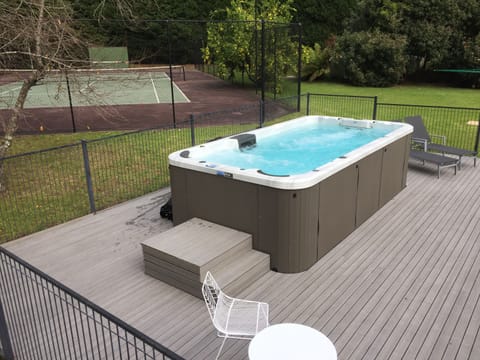 Giant swim spa & full size concrete tennis court