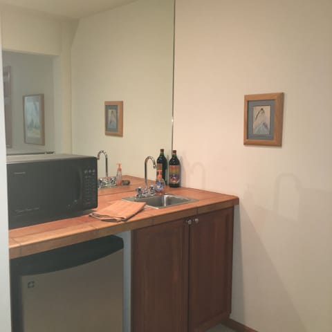 Lower-level bar area with refrigerator and sink...