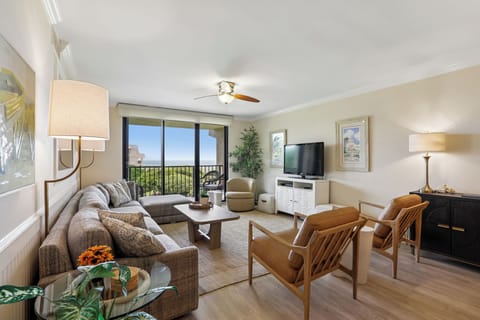 Your beautifully appointed living space features comfortable seating, warm lighting, and a private balcony where you can unwind while taking in the lush greenery beyond.