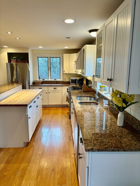 Full stocked kitchen and butcher block bar.