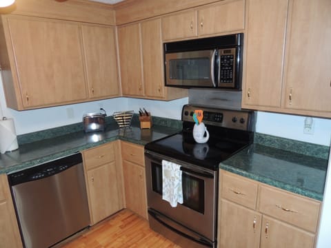Full kitchen with stainless appliances and full service utensils, service for 8. 