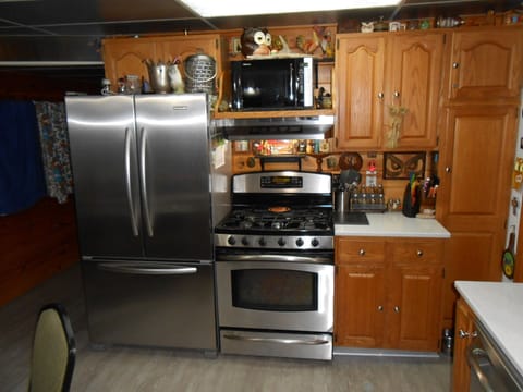 Stainless appliances gas stove top electric oven microwave lots of cookware