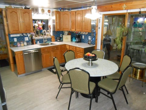 Eat-in kitchen with round table with extra chairs available.