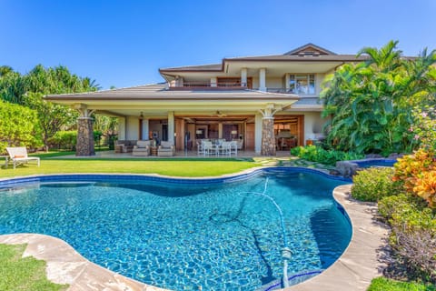Relax in your own tropical oasis, complete with a sparkling pool, soothing spa, and gentle waterfall surrounded by lush greenery.