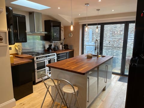 The well equipped kitchen with 2 fridges and a separate freezer, range cooker