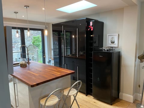 The kitchen has large bifold doors leading to the rear decking