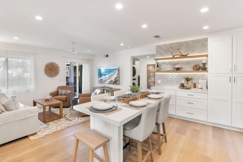 Open dining island, coffee bar and living area.