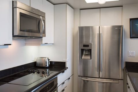 Modern kitchen with stainless appliances.