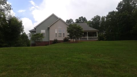 Gently rolling yard leads up to front porch
