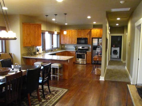 View across Dining, into kitchen and down hall to Laundry nook