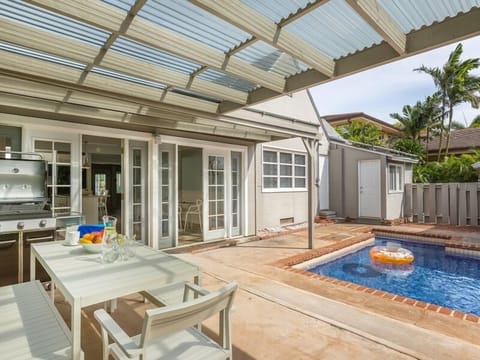 Host a backyard barbecue in this covered outdoor lanai by the pool.