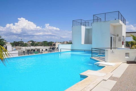 Soak in the sun at our stunning rooftop pool with city views.