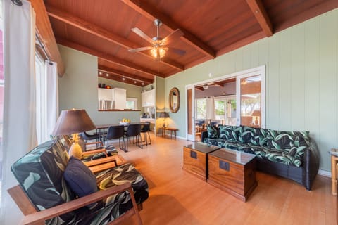 Open living/dining area looking into kitchen and through doors to the lanai