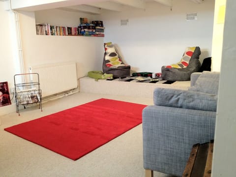 Basement playroom/living room with pinball and table football.