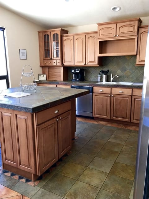 Cherry Cabinets in Kitchen with Stainless Steel Appliances
