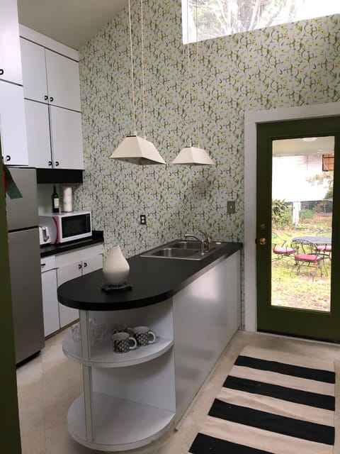 Kitchen / opens out onto a backyard w/ Deck.