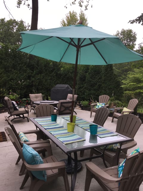 Back patio with gas fire pit and grill. Surrounded by lovely gardens and woods. 