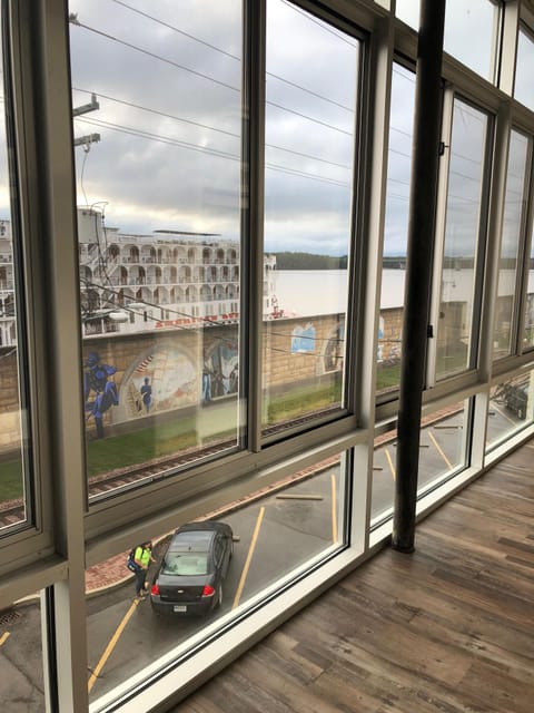Balcony view of the Mississippi with a steamboat docked outside