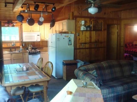Bathroom is behind wall with blender on shelf.