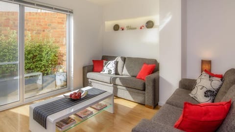 Lounge area with sliding glass door onto small courtyard area.
