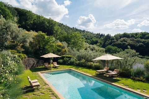 Marble-lined pool with loungers for all-day relaxation.
