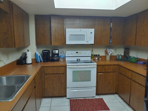 Kitchen with full oven, 4 burner glass top stove, full size microwave