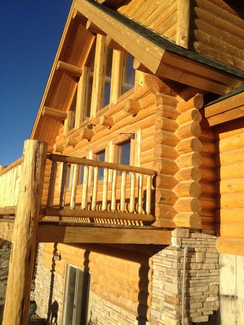 Afternoon sun on wrap around deck with gas grille & patio set.