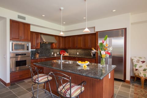 The granite top kitchen features premium appliances and is fully equipped.