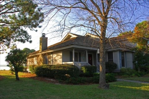 View of front of house. View of water can be seen in background