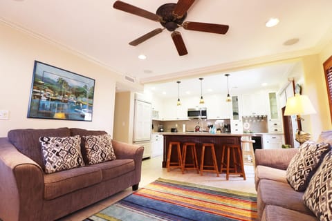 Living room with two couches and easy access to front patio through sliding door!