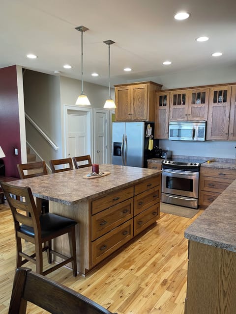 Kitchen appliances include an electric stove with a convection oven.