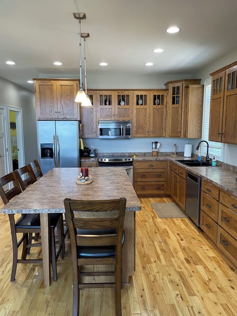 Paper products, small appliances, & plastic containers stored in the island.