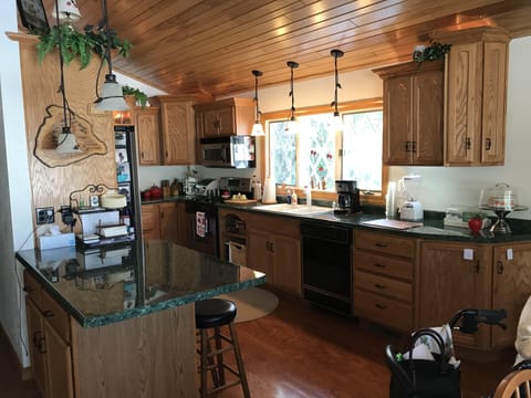 Kitchen with full utensils.