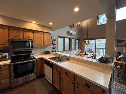 Fully stocked kitchen is open to living and dining areas
