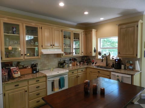 Full kitchen with cookware, dishes, and utensils.